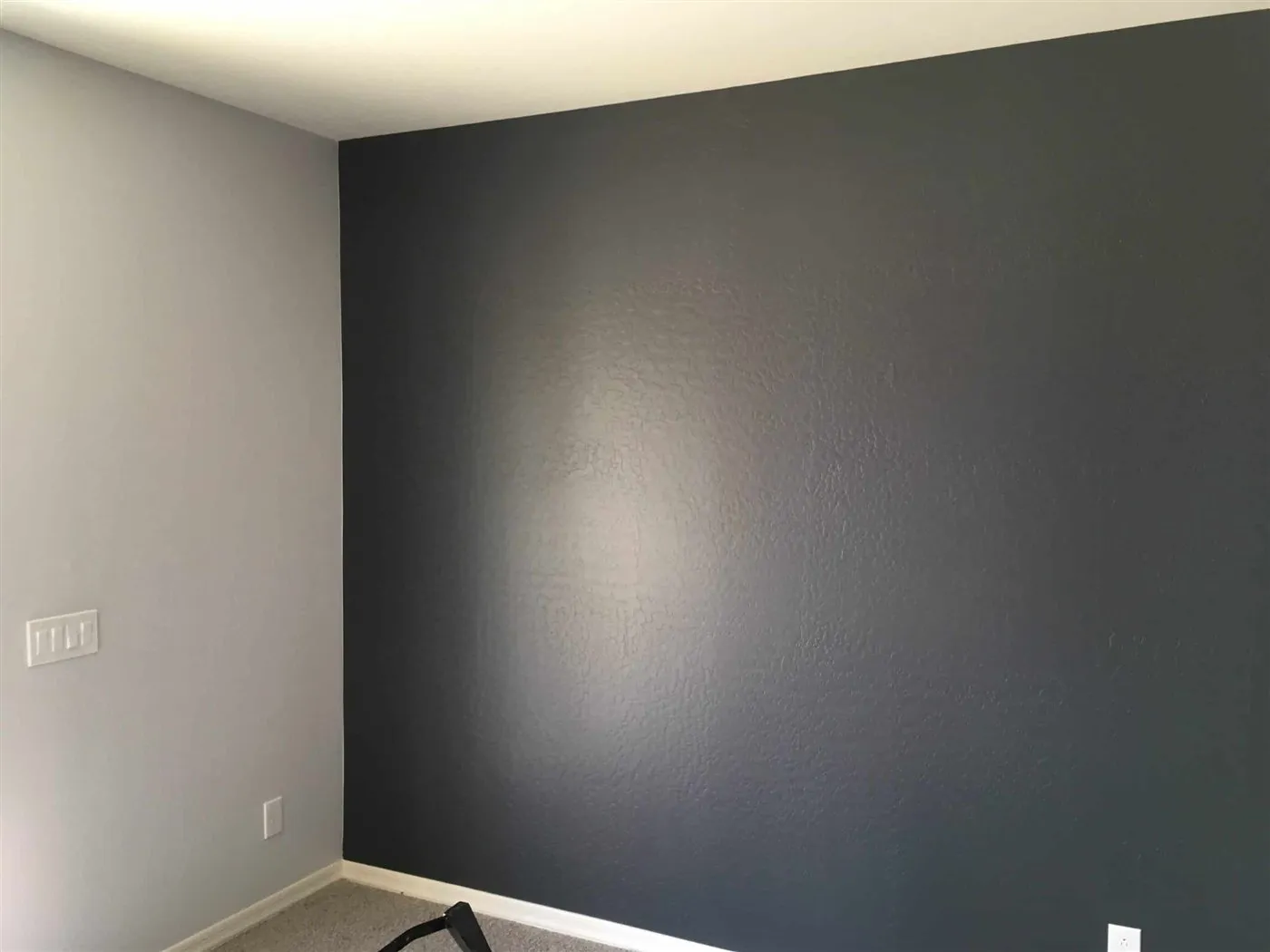 Charcoal accent wall next to a light gray wall in an Arizona home interior painted by ACP Painting