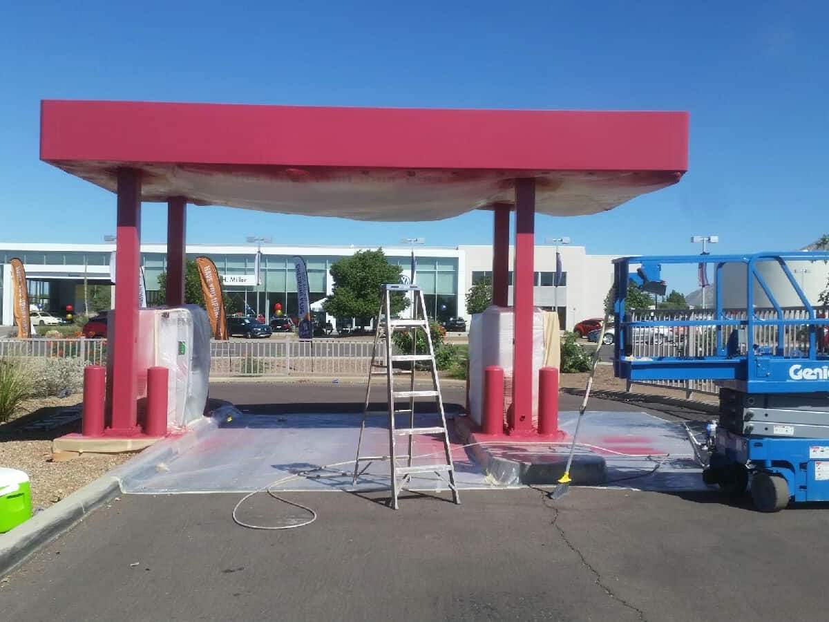 ACP Painting working from a lift on a commercial canopy repaint