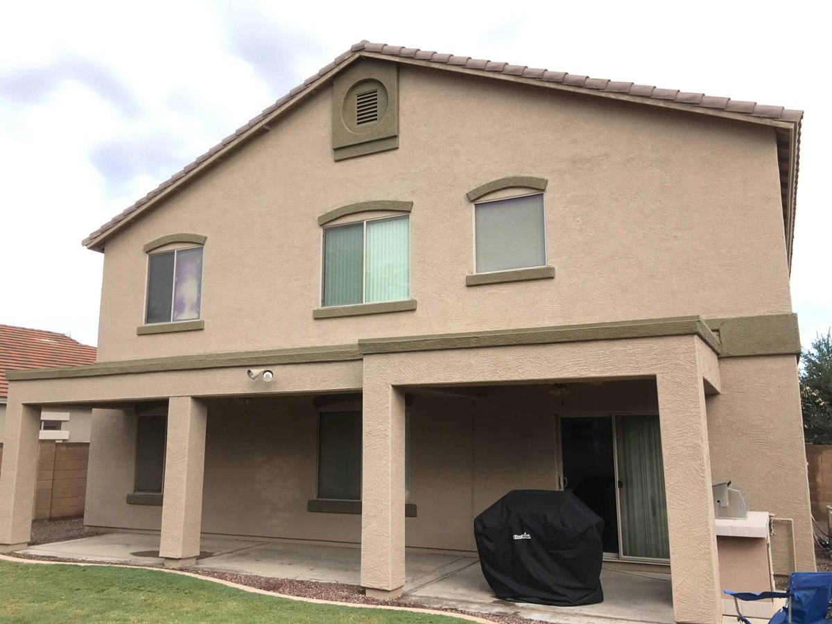 Two-story Arizona home after an exterior repaint in a neutral desert palette
