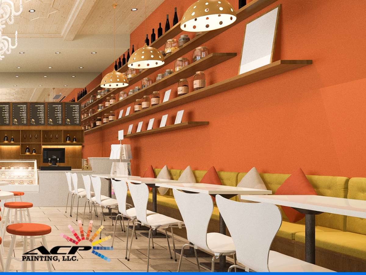 Cozy restaurant interior featuring warm paint colors with orange walls, yellow seating, and stylish white chairs