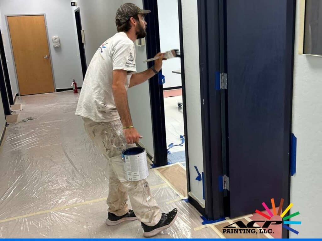ACP Painting technician working on a school painting project in a hallway