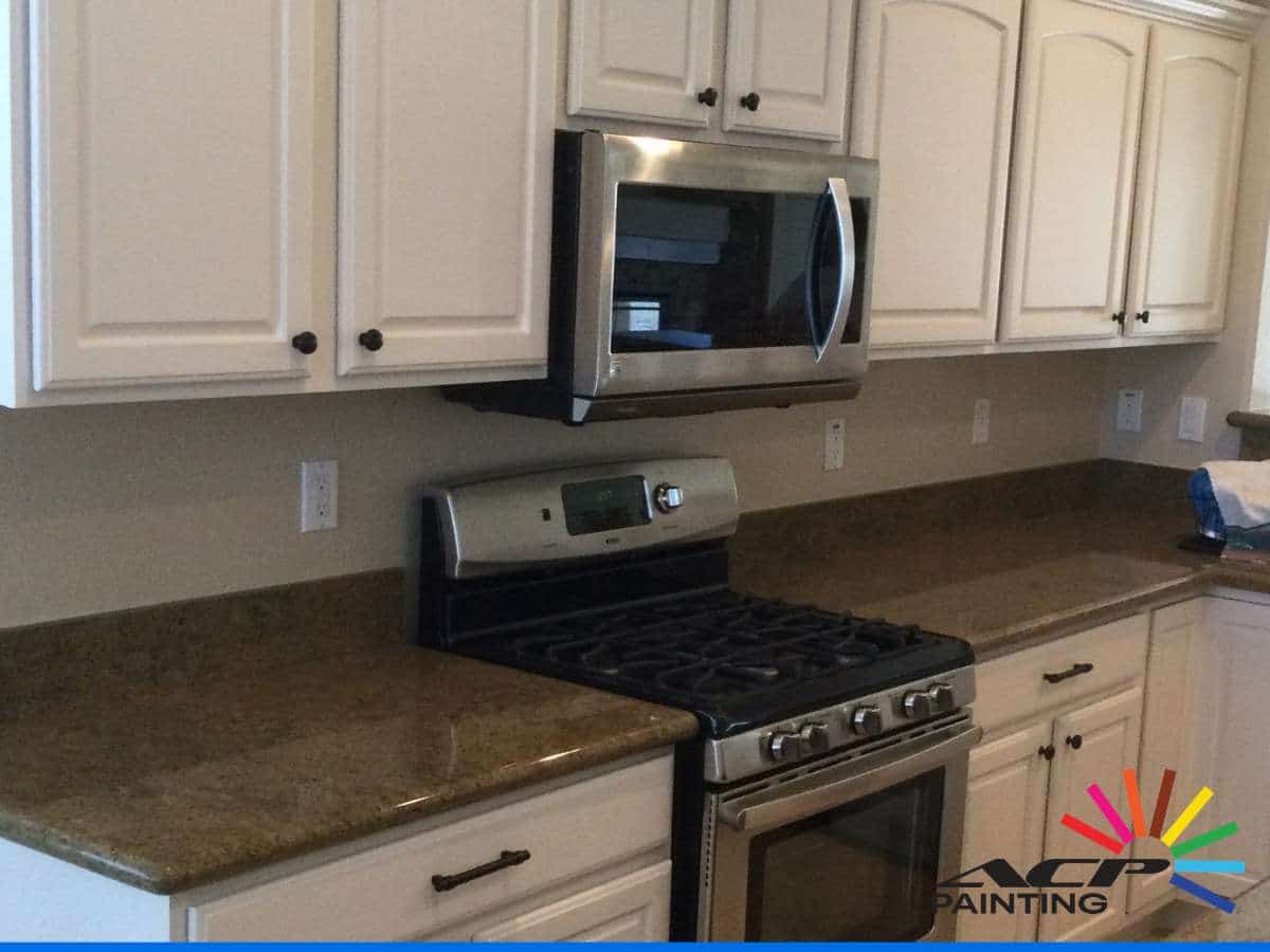 White Cabinets and Trim Yellow in Arizona Homes showing kitchen cabinetry.